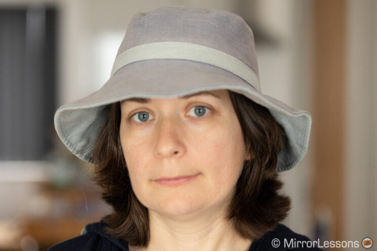Woman wearing a hat, indoor background, image out of focus