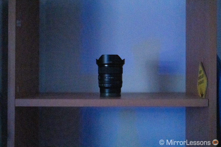 black lens on a shelf in near dark conditions