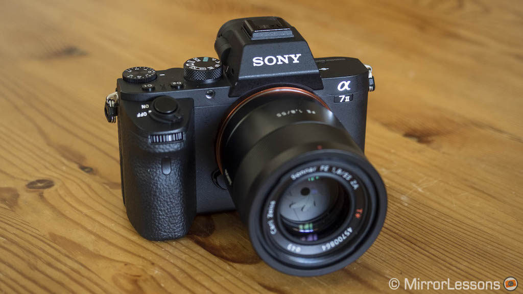 Sony A7 II on a wooden table, with 55mm F1.8 lens attached