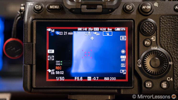 rear monitor of the A7 IV, recording video and displaying a red frame on the screen